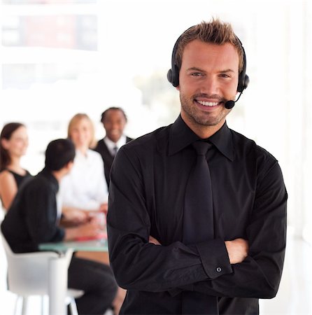 simsearch:400-04129170,k - Young Businessman with headset on in office environment Fotografie stock - Microstock e Abbonamento, Codice: 400-04111009