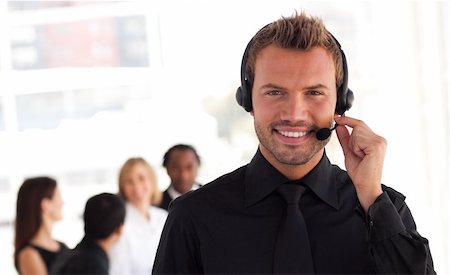 simsearch:400-04129170,k - Young Businessman with headset on in office environment Fotografie stock - Microstock e Abbonamento, Codice: 400-04111011