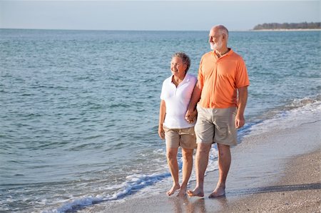 senior woman exercising by ocean - Happy senior couple enjoys a romantic stroll on the beach. Stock Photo - Budget Royalty-Free & Subscription, Code: 400-04111505