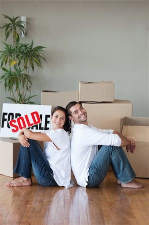 family with sold sign - Young Couple relaxing after buying house Stock Photo - Budget Royalty-Free & Subscription, Code: 400-04111763