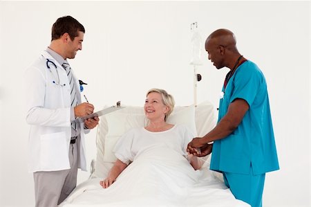 simsearch:400-08294547,k - Team of Doctors with a Patient Stockbilder - Microstock & Abonnement, Bildnummer: 400-04112070