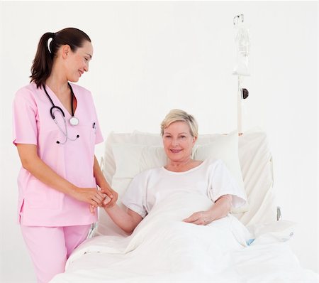 simsearch:400-04311151,k - Young Nurse measuring an elderly patients Pulse Stockbilder - Microstock & Abonnement, Bildnummer: 400-04112086