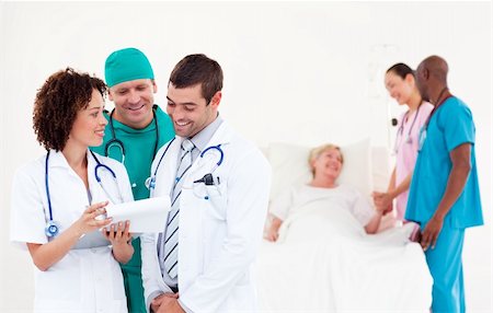 Team of Doctors with a patient Stock Photo - Budget Royalty-Free & Subscription, Code: 400-04112116