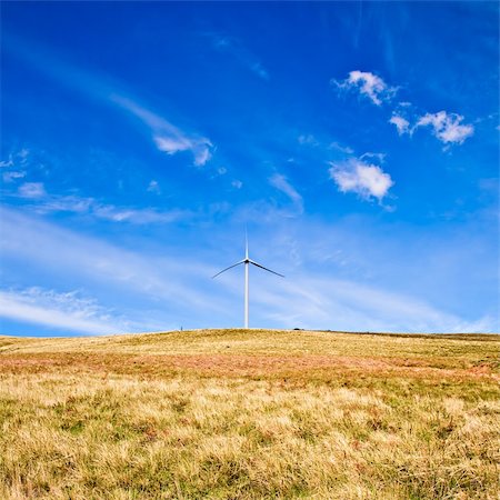 simsearch:400-04339274,k - Wind tower on a field with blue sky. Fotografie stock - Microstock e Abbonamento, Codice: 400-04113105