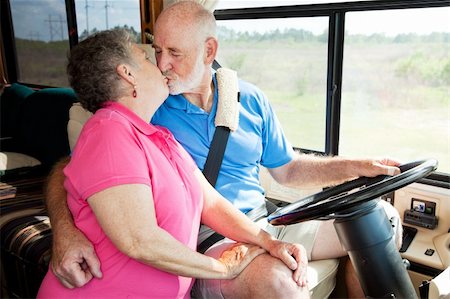 senior couple rv - Vacationing senior couple kissing while he is driving their motor home. Stock Photo - Budget Royalty-Free & Subscription, Code: 400-04113508