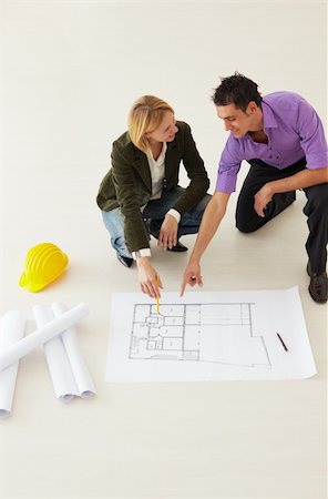 high angle view of male architect and woman examining blueprints. Copy space Stock Photo - Budget Royalty-Free & Subscription, Code: 400-04124213