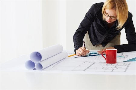 portrait of female architect drawing line on blueprint. Copy space Stock Photo - Budget Royalty-Free & Subscription, Code: 400-04124221