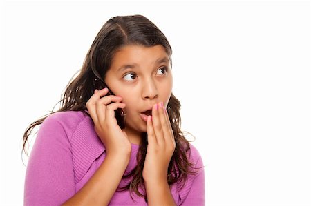 simsearch:400-04001639,k - Shocked Pretty Hispanic Girl On Cell Phone Isolated on a White Background. Foto de stock - Super Valor sin royalties y Suscripción, Código: 400-04124328