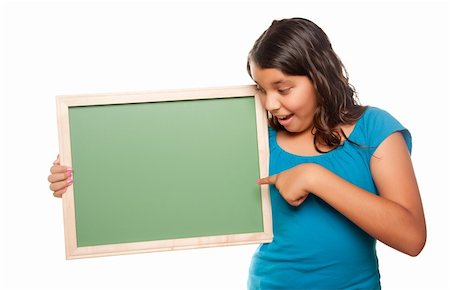 simsearch:400-04125503,k - Fille jolie hisoire pointant et Holding Blank Chalkboard isolé sur fond blanc. Photographie de stock - Aubaine LD & Abonnement, Code: 400-04124336