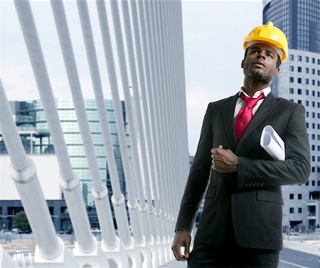 African american architect engineer with yellow hardhat and plans Stock Photo - Budget Royalty-Free & Subscription, Code: 400-04124538