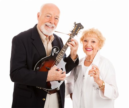 sérénade - Senior homme joue de la musique sur sa mandoline tandis que sa femme chante le long. Isolé Photographie de stock - Aubaine LD & Abonnement, Code: 400-04124579