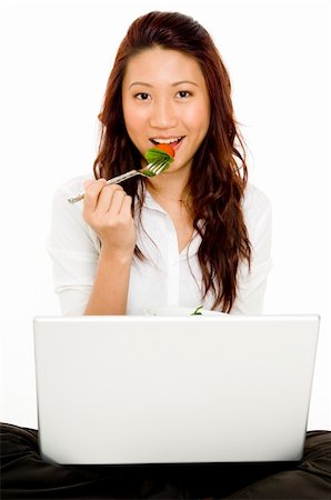 A young asian businesswoman eats lunch at her computer Stock Photo - Budget Royalty-Free & Subscription, Code: 400-04125102