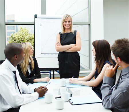 simsearch:400-05155599,k - Attractive businesswoman standing in a meeting with folded arms Stock Photo - Budget Royalty-Free & Subscription, Code: 400-04125247
