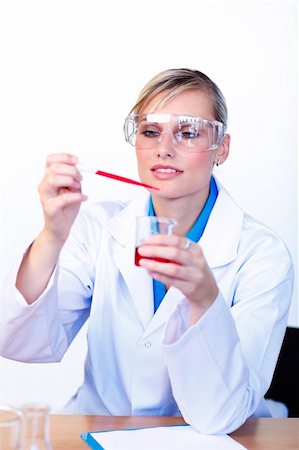 simsearch:400-05669824,k - Beautiful young scientist examining a test-tube Foto de stock - Royalty-Free Super Valor e Assinatura, Número: 400-04125254