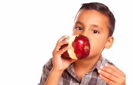 Adorable Hispanic Boy Eating a Large Red Apple Isolated on a White Background. Stock Photo - Budget Royalty-Free & Subscription, Code: 400-04125525