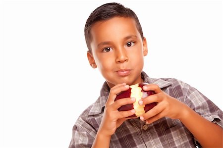 Adorable Hispanic Boy Eating a Large Red Apple Isolated on a White Background. Stock Photo - Budget Royalty-Free & Subscription, Code: 400-04125527