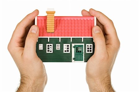 roof and hands - Protective hand holding a modelhouse Stock Photo - Budget Royalty-Free & Subscription, Code: 400-04125668