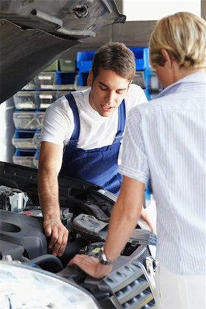 propietario de coche (hombre y mujer) - mechanic talking with female client in auto repair shop. Foto de stock - Super Valor sin royalties y Suscripción, Código: 400-04126663