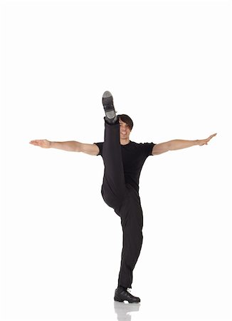 Single Caucasian male tap dancer wearing black pants and t-shirt showing various steps in studio with white background and reflective floor. Not isolated Stock Photo - Budget Royalty-Free & Subscription, Code: 400-04127049