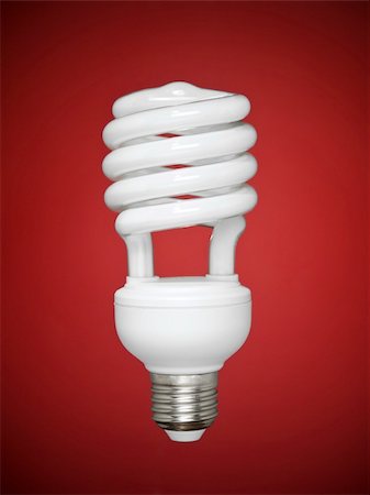 simsearch:400-05248280,k - Compact fluorescent light bulb over a red background. Foto de stock - Super Valor sin royalties y Suscripción, Código: 400-04127353