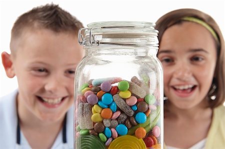 spoiled for choice - young girl and boy looking with excitement at candy jar Stock Photo - Budget Royalty-Free & Subscription, Code: 400-04127986