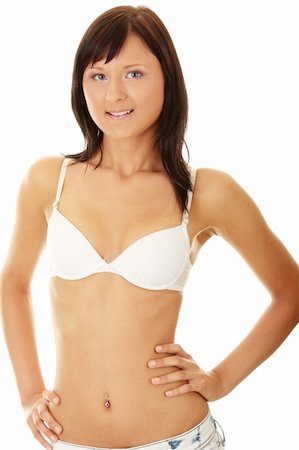 simsearch:400-04863372,k - Jeune femme sexy en soutien-gorge et jeans isolés sur fond blanc Photographie de stock - Aubaine LD & Abonnement, Code: 400-04128427