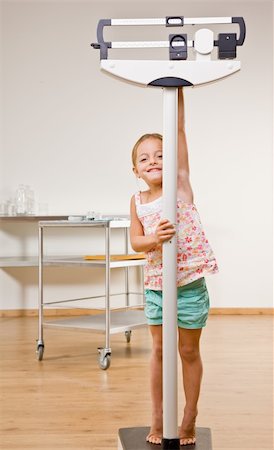 Girl weighing herself in doctorÕs office Stock Photo - Budget Royalty-Free & Subscription, Code: 400-04128642