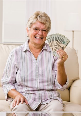 Senior woman holding cash Stock Photo - Budget Royalty-Free & Subscription, Code: 400-04128702