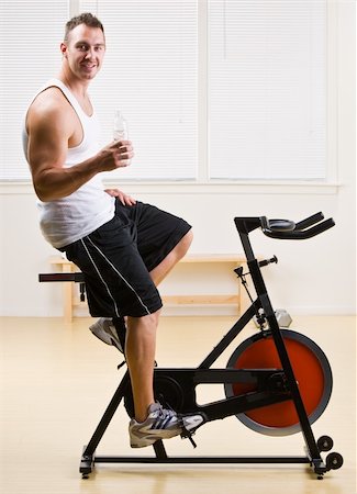 Man riding stationary bicycle in health club Stock Photo - Budget Royalty-Free & Subscription, Code: 400-04128774