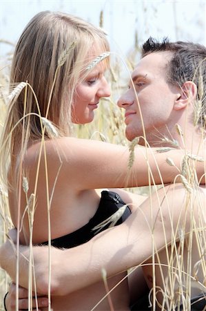 A beautiful couple sitting an kissing in wheat field Stock Photo - Budget Royalty-Free & Subscription, Code: 400-04129112