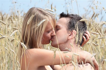 A beautiful couple sitting an kissing in wheat field Stock Photo - Budget Royalty-Free & Subscription, Code: 400-04129113