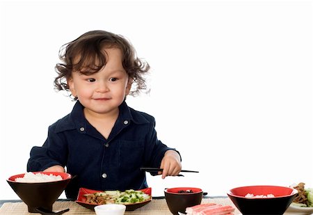 simsearch:695-05778625,k - Little boy eating asian food, isolated on a white background. Stock Photo - Budget Royalty-Free & Subscription, Code: 400-04129476