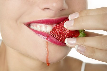 Closeup macro of woman eating a juicy strawberry Stock Photo - Budget Royalty-Free & Subscription, Code: 400-04129747