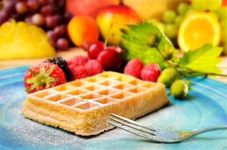 simsearch:400-07061592,k - waffles with icing sugar and tropic fruits in the background Stock Photo - Budget Royalty-Free & Subscription, Code: 400-04120245
