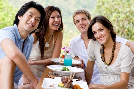 eastwestimaging (artist) - A group of young adults having lunch on vacation Fotografie stock - Microstock e Abbonamento, Codice: 400-04120274