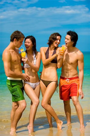 friends drinking juice - Four young adults standing by ocean with drinks Stock Photo - Budget Royalty-Free & Subscription, Code: 400-04120285