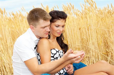 Attractive couple in the field looking at a wheat ear Stock Photo - Budget Royalty-Free & Subscription, Code: 400-04120432