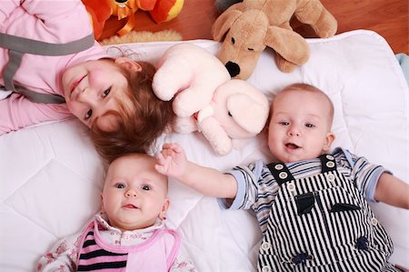 simsearch:400-04161658,k - Cute siblings with toys lying Fotografie stock - Microstock e Abbonamento, Codice: 400-04121008