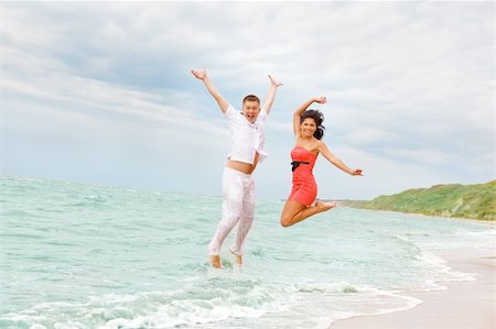 A joyful couple jumping in the sea Stock Photo - Budget Royalty-Free & Subscription, Code: 400-04121034