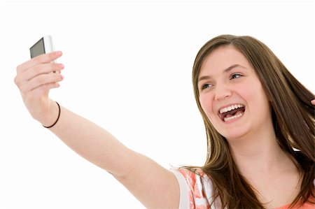 Caucasian teenager using a cell to take a pictue of herself on white background Stock Photo - Budget Royalty-Free & Subscription, Code: 400-04121311