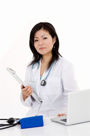 simsearch:400-05172792,k - Beautiful Asian woman Doctor/Nurse working at a desk Foto de stock - Royalty-Free Super Valor e Assinatura, Número: 400-04121327