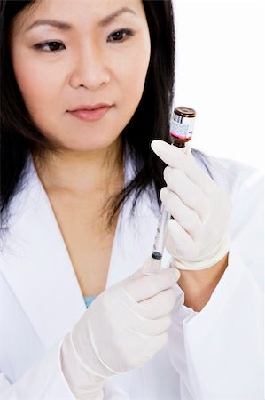 Beautiful Asian doctor or nurse preparing a vaccination Stock Photo - Budget Royalty-Free & Subscription, Code: 400-04121332
