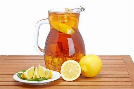 Ice tea pitcher with lemon and icecubes on wooden background Stock Photo - Budget Royalty-Free & Subscription, Code: 400-04121373