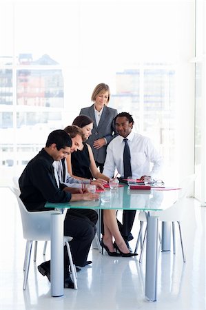 simsearch:400-04187120,k - International business team studying a new business plan in office Stock Photo - Budget Royalty-Free & Subscription, Code: 400-04121382