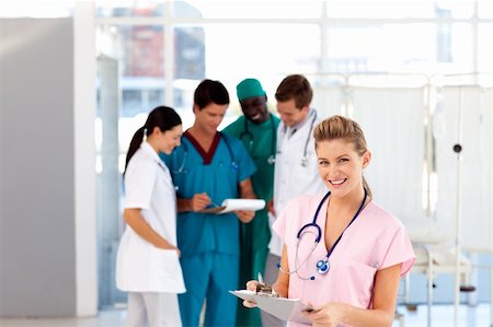 Beautiful nurse with her team in the background in hospital Stock Photo - Budget Royalty-Free & Subscription, Code: 400-04121417