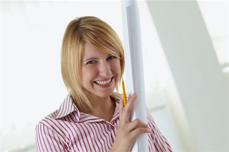 simsearch:400-04124220,k - portrait of young adult architect holding blueprint and smiling. Copy space Foto de stock - Super Valor sin royalties y Suscripción, Código: 400-04121622