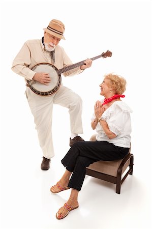 sérénade - Senior man serenading his lady on his banjo.  Isolated on white. Photographie de stock - Aubaine LD & Abonnement, Code: 400-04121878