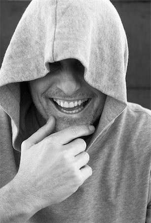 A happy laughing man with stubble is wearing a hooded top in black and white. Foto de stock - Super Valor sin royalties y Suscripción, Código: 400-04122423