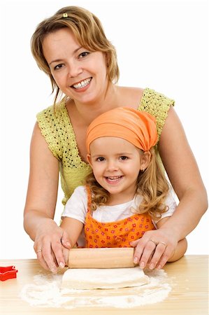 flour daughter - Happy woman and little girl stretching the dough together - isolated Stock Photo - Budget Royalty-Free & Subscription, Code: 400-04122843