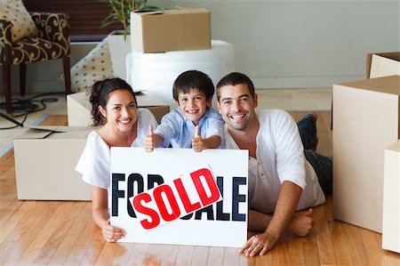 family with sold sign - Happy family lying on the floor after buying new house Stock Photo - Budget Royalty-Free & Subscription, Code: 400-04123026